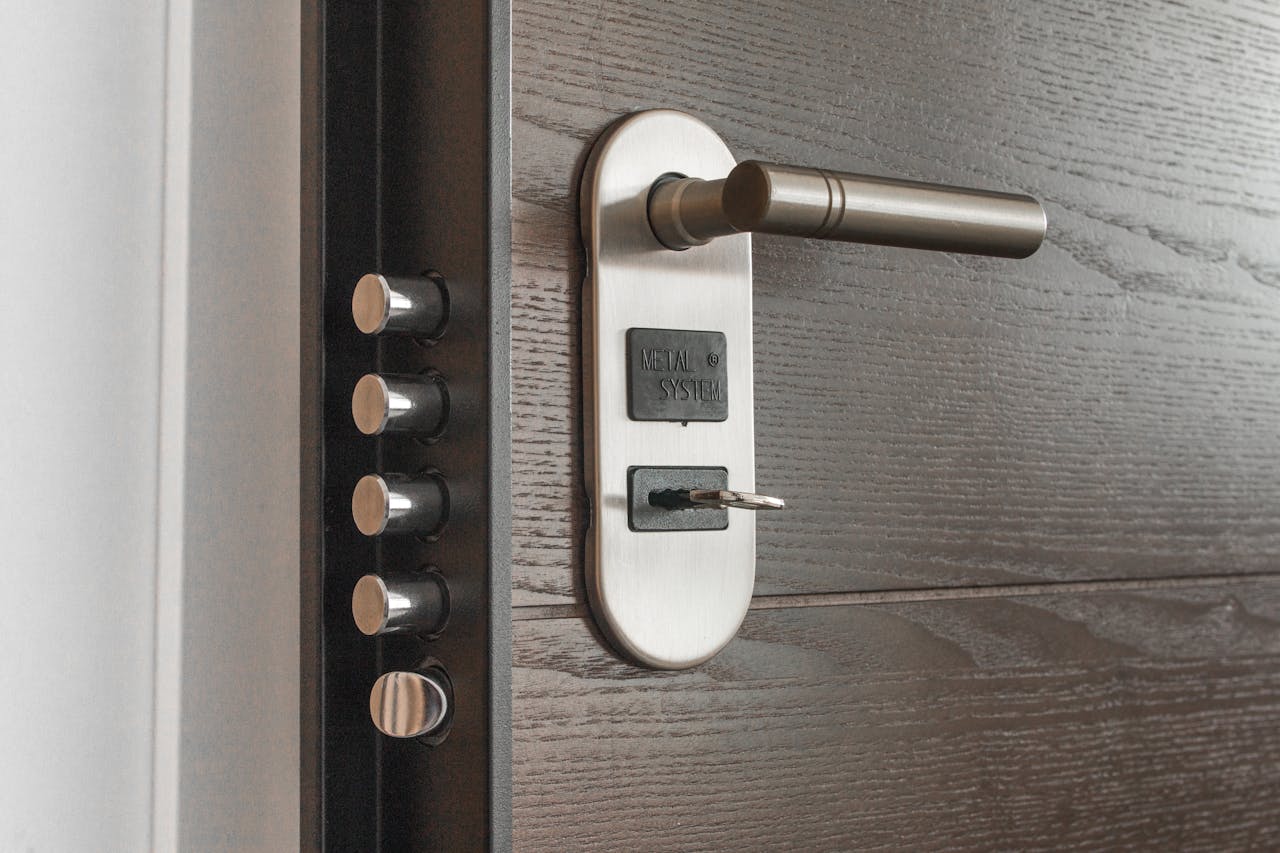 who-we-are Metal door handle and lock system with key inserted, showcasing security features.